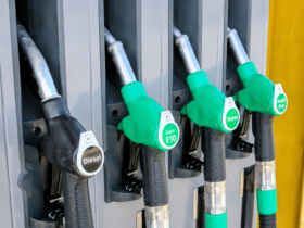 High-resolution image of diesel and petrol fuel pump nozzles at a gas station during rising global oil price concerns.