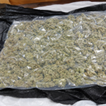 Border security officers inspect luggage during a Thailand cannabis smuggling investigation at an international airport.