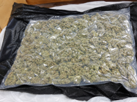 Border security officers inspect luggage during a Thailand cannabis smuggling investigation at an international airport.