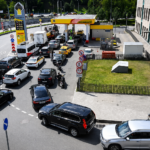 Cars waiting in long queues at a petrol station during Russian fuel shortages caused by attacks on energy infrastructure.